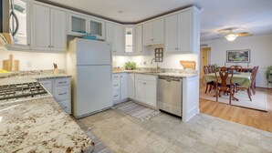 A modern kitchen with white cabinets, a built-in stove, and a dishwasher. - Deck & Pasture Views! Bealeton Farmhouse Escape (Bealeton)