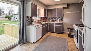 A kitchen with grey cabinets, a dishwasher, a stove, and a refrigerator. - Homey Duplex - 10 Mi to Downtown Grand Rapids! (Jenison)
