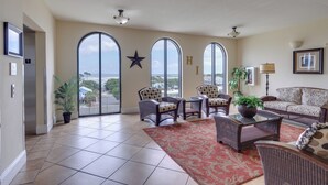 A spacious living room with large windows, a star decoration, and a view of the outdoors.