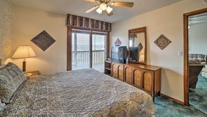 A bedroom with a bed, a ceiling fan, a television, and a dresser. - Branson Condo w/ Views: 2 Mi to Silver Dollar City (Branson West)