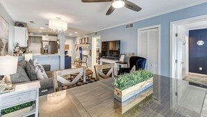 A spacious living room with a dining area, a kitchen in the background, and a ceiling fan. - Walk to Beach: Hilton Head Resort Condo w/ Pools! (Hilton Head Island)