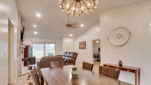A spacious dining area with a wooden table, chairs, and a chandelier. - Lovely Massanutten Getaway w/ Resort Access! (McGaheysville)