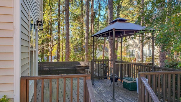 A wooden deck with a gazebo, surrounded by tall trees. - Wendell Home w/ Fenced Yard, Close to Raleigh (Wendell)