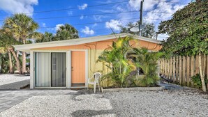 A small, single-story building with a sliding glass door and a small porch area. - Remodeled Siesta Key Studio Near Beach! (Siesta Key)