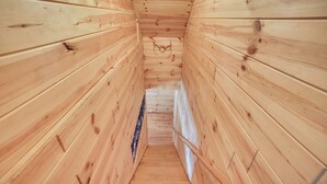 A wooden interior with a narrow staircase leading to a higher level. - 6 Mi to Shingleton: Manistique Home w/ Yard! (Manistique)