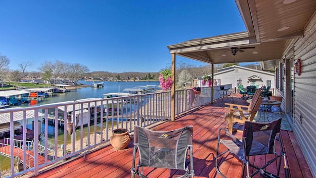 A covered deck with outdoor furniture, a view of the lake, and docked boats. - Private Dock, Waterfront Views! Sunrise Beach Home (Sunrise Beach)