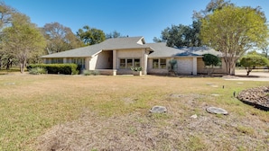 A single-story house with a brick facade, a covered porch, and a well-maintained lawn. - Pool, Patio & Privacy! Home Near Georgetown Square (Georgetown)