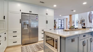 A modern kitchen with white cabinets, a stainless steel refrigerator, an oven, and a microwave. - Pool, Patio & Privacy! Home Near Georgetown Square (Georgetown)