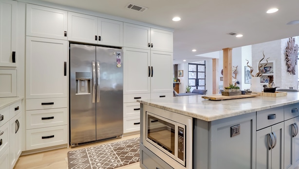 A modern kitchen with white cabinets, a stainless steel refrigerator, an oven, and a microwave. - Pool, Patio & Privacy! Home Near Georgetown Square (Georgetown)
