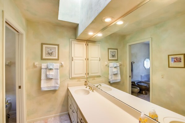 A bathroom with a white vanity, double sinks, and a large mirror. - Spacious & Secluded Madison Home Near Dtwn! (Madison)