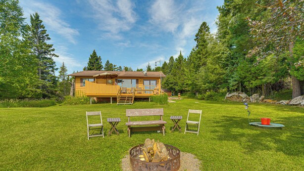 A lodge with a fire pit, outdoor seating, and a wooden deck. - 15 Mi to Duluth: Lake Superior Beachfront Home! (Duluth)