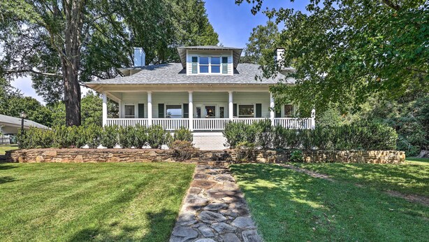 A two-story house with a stone pathway leading to the front porch. - Lush Elkin Home w/ Porch Views & Pool Table (Elkin)
