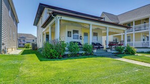 A two-story house with a covered porch, a front yard with a lawn, and a small garden. - Jersey Shore Getaway w/ Grill: Walk to Beach! (Belmar)