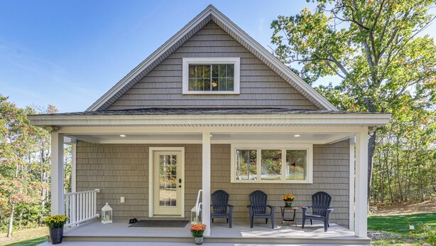 A two-story house with a covered porch, two windows, and a door. - Sunny Stockton Springs Home < 1 Mi to Beach! (Stockton Springs)