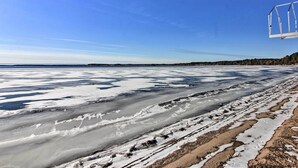 A frozen lake with a ski lift in the background. - Waterfront Whitefish Lake Home w/ Dock! (Pine River)