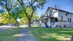 A two-story house with a front porch, a driveway, and a lawn. - Wfh-friendly Billings Apt ~ 1 Mi to Downtown! (Billings)