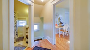A hallway with a wooden floor, a white door, and a small window. - Wfh-friendly Billings Apt ~ 1 Mi to Downtown! (Billings)
