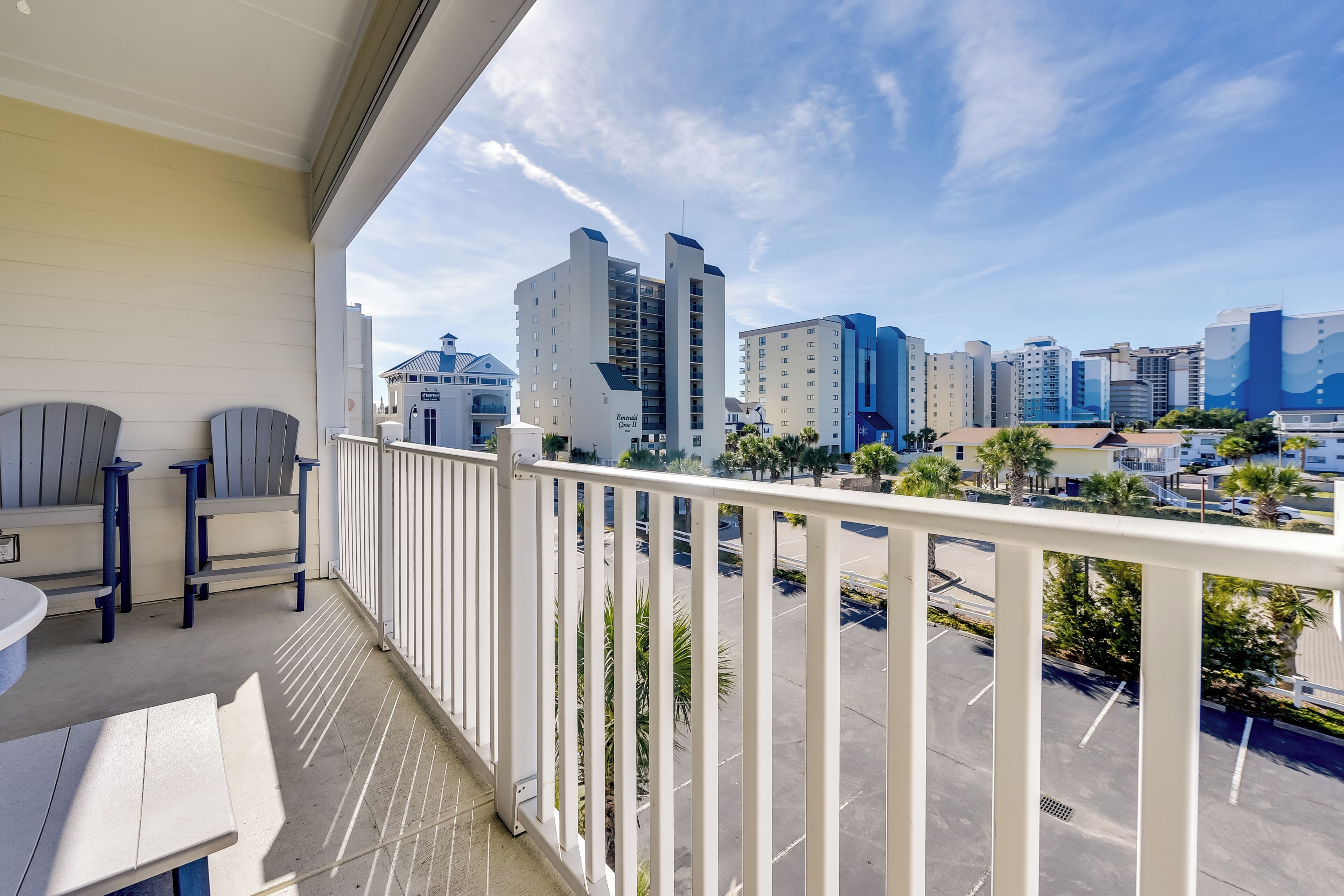 A balcony with a view of a cityscape, including a tall building labeled 'Family Inn'.