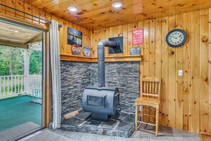 A wooden interior with a stone fireplace, a clock, and a sign indicating a grilling timer. - Lakefront Gloversville Home w/ Beach + Dock! (Gloversville)