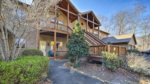 A two-story building with a wooden exterior, a covered porch, and a stone pathway leading to the entrance. - Beautiful Whittier Condo w/ Deck + Mtn Views! (Whittier)