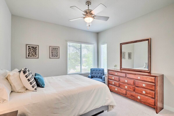 A bedroom with a bed, dresser, and ceiling fan. - Gorgeous Georgetown Home, Walk to the Square! (Georgetown)