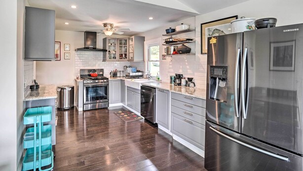 A modern kitchen with stainless steel appliances, a built-in oven, and a dishwasher.