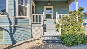 A two-story house with a porch, a small staircase, and a garden. - Charming Santa Paula Home - Walk to Downtown! (Santa Paula)