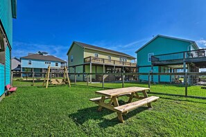 A fenced outdoor area with a picnic table and playground equipment. - Walk to Crystal Beach: Coastal Home w/ Views! (Port Bolivar)