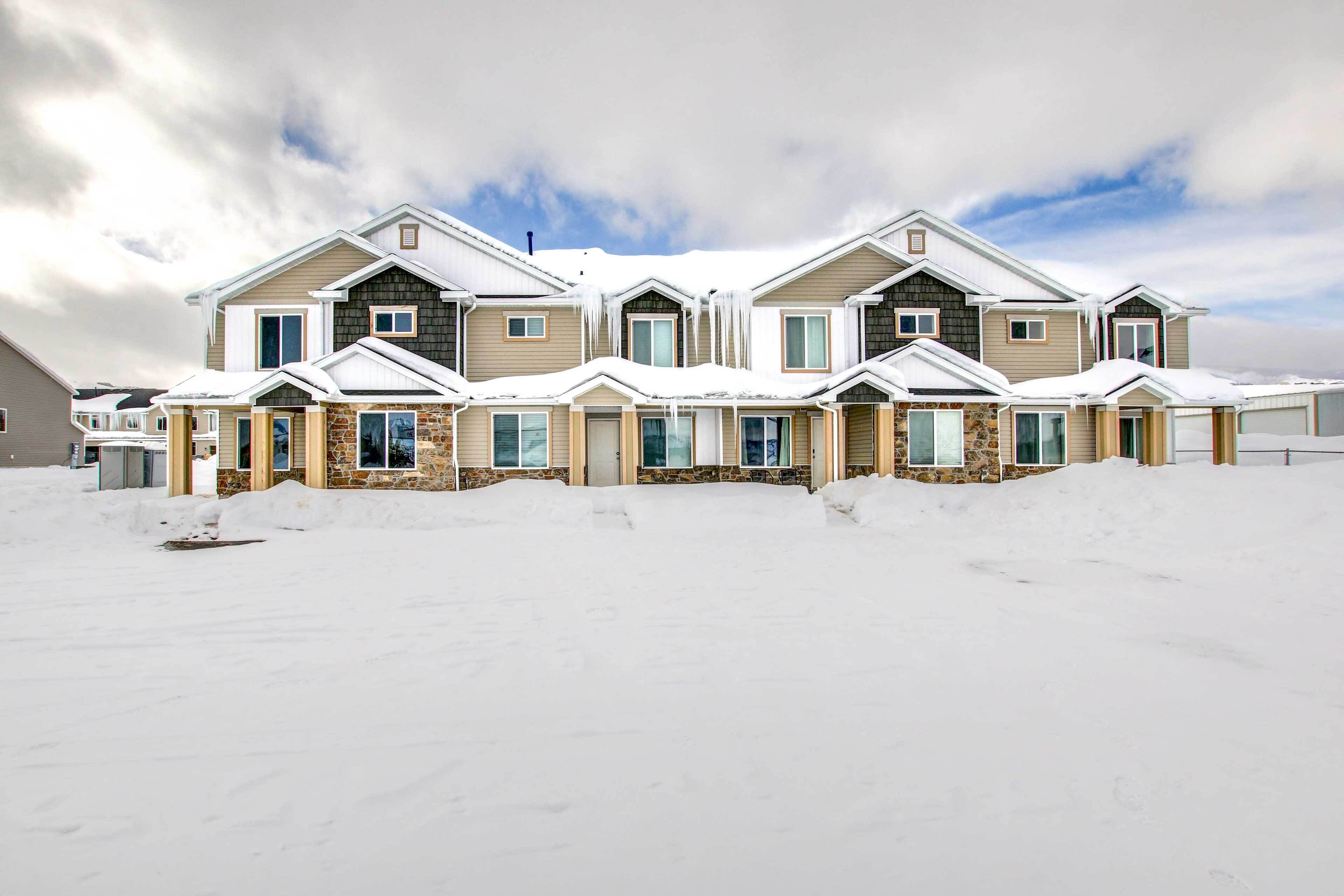 A row of modern, two-story houses with a snow-covered landscape.