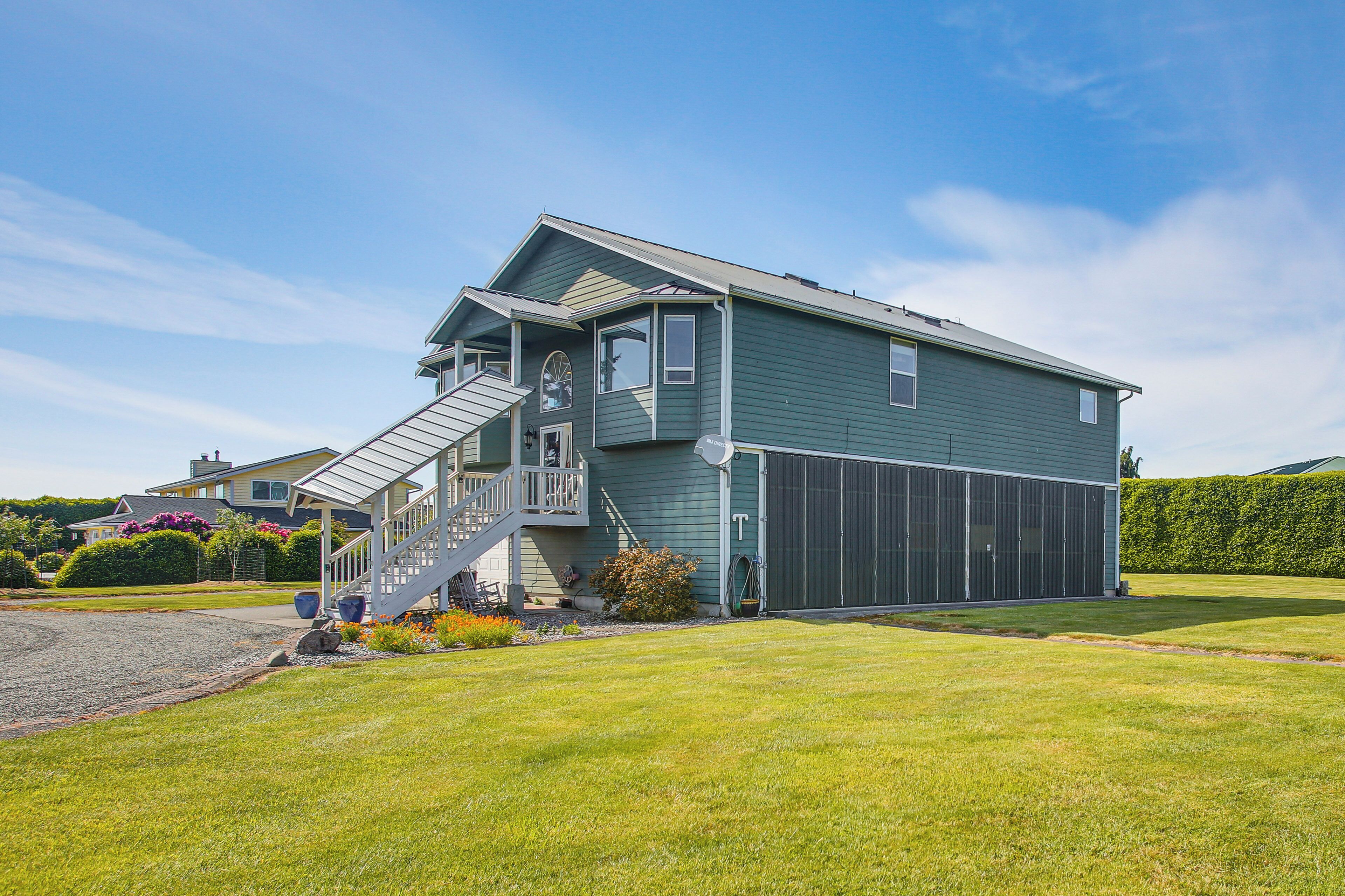A two-story house with a front porch, a staircase, and a garage.
