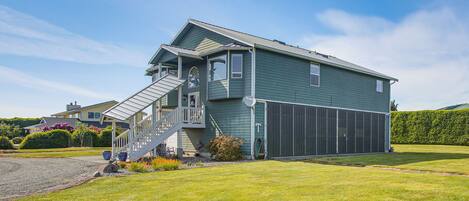 A two-story house with a front porch, a staircase, and a garage.