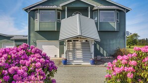 A two-story house with a garage, a covered front porch, and a driveway. - Charming Sequim House w/ Olympic Peninsula Views! (Sequim)