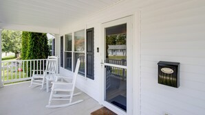 A porch with white rocking chairs and a mailbox. - Charming Somers Point House w/ Private Pool! (Somers Point)