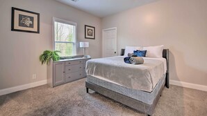 A bedroom with a bed, a dresser, a window, and a door. - Chic Atlanta Home < 4 Mi to Mercedes-benz Stadium! (Atlanta)