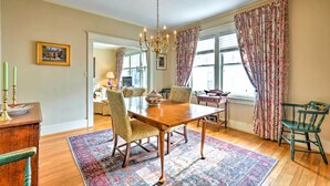 A dining room with a wooden table, chairs, a chandelier, and a patterned rug. - Lovely Apt, 1 Block to Downtown Danville (Danville)