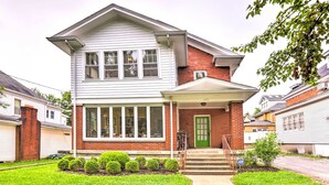 A two-story house with a front porch, a green door, and a small front yard with trimmed bushes. - Lovely Apt, 1 Block to Downtown Danville (Danville)