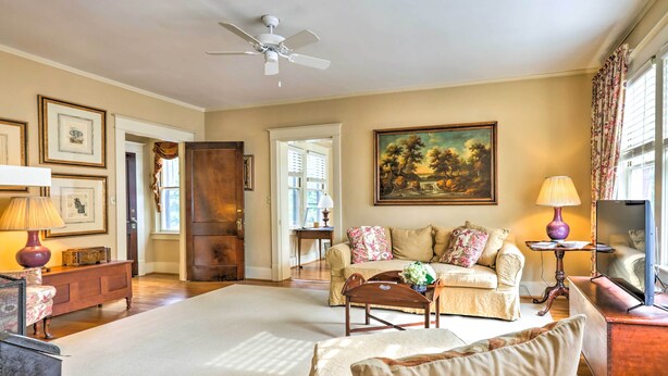 A spacious living room with a large white rug, a ceiling fan, a sofa set, a coffee table, and a painting on the wall. - Lovely Apt, 1 Block to Downtown Danville (Danville)