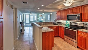 A spacious kitchen with wooden cabinets, stainless steel appliances, and a large island.