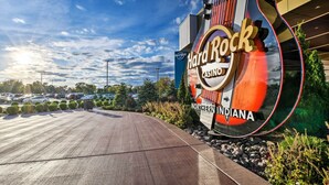 A Hard Rock Casino sign with a guitar design, located next to a parking lot. - Renovated Griffith Family Home in Chicagoland Area (Griffith)
