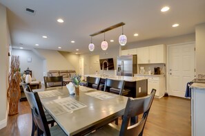A modern kitchen with a central island, recessed lighting, and pendant lights.