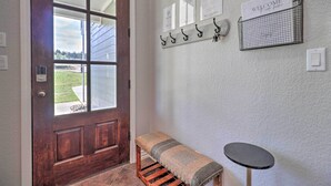 A wooden door with a bench and a small table in front. - Lake LBJ Waterfront Vacation Rental! (Marble Falls)