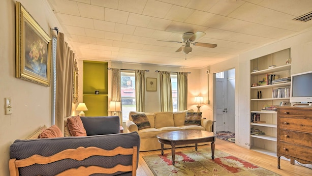 A living room with a sofa, armchairs, a coffee table, and a bookshelf. - Pet-friendly Roxbury Farmhouse on 350 Acres! (Roxbury)