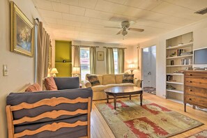 A living room with a sofa, armchairs, a coffee table, and a bookshelf. - Pet-friendly Roxbury Farmhouse on 350 Acres! (Roxbury)