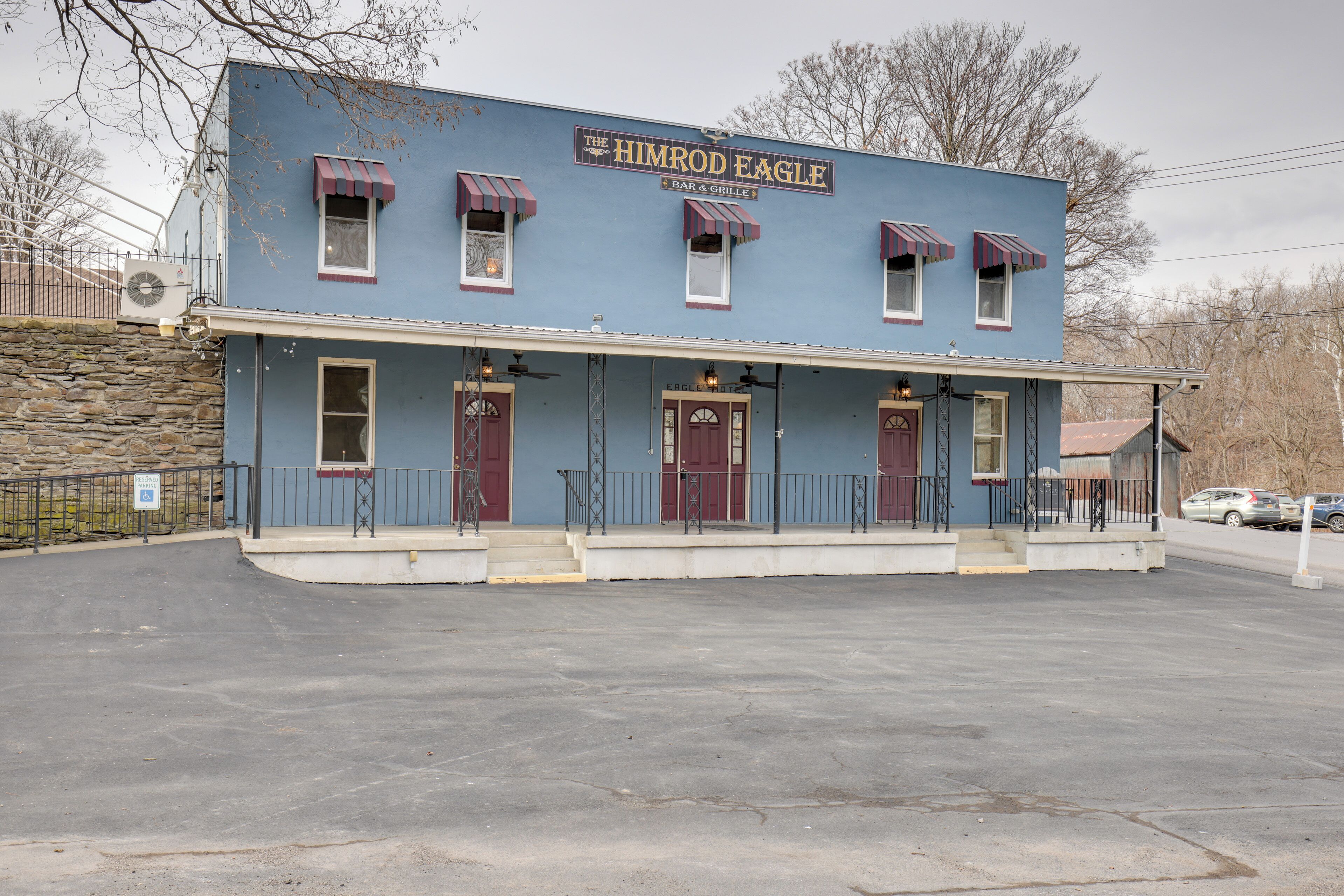 A two-story building with a sign reading "The Himrod Eagle Bar & Grill."