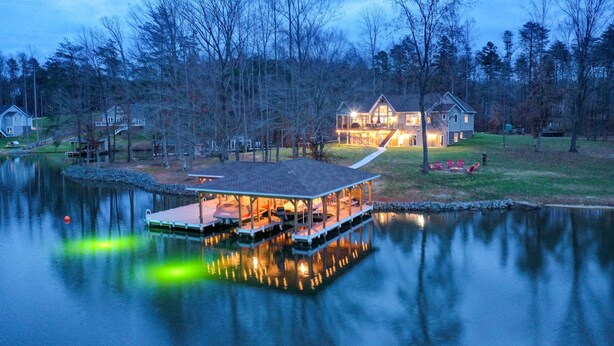 A lakeside house with a dock and a covered outdoor area. - Lake Anna Home w/ Dock & Private Shoreline! (Bumpass)