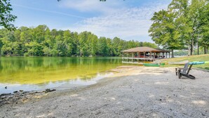 A lakeside pavilion with a covered seating area and a sandy beach. - Lake Anna Home w/ Dock & Private Shoreline! (Bumpass)