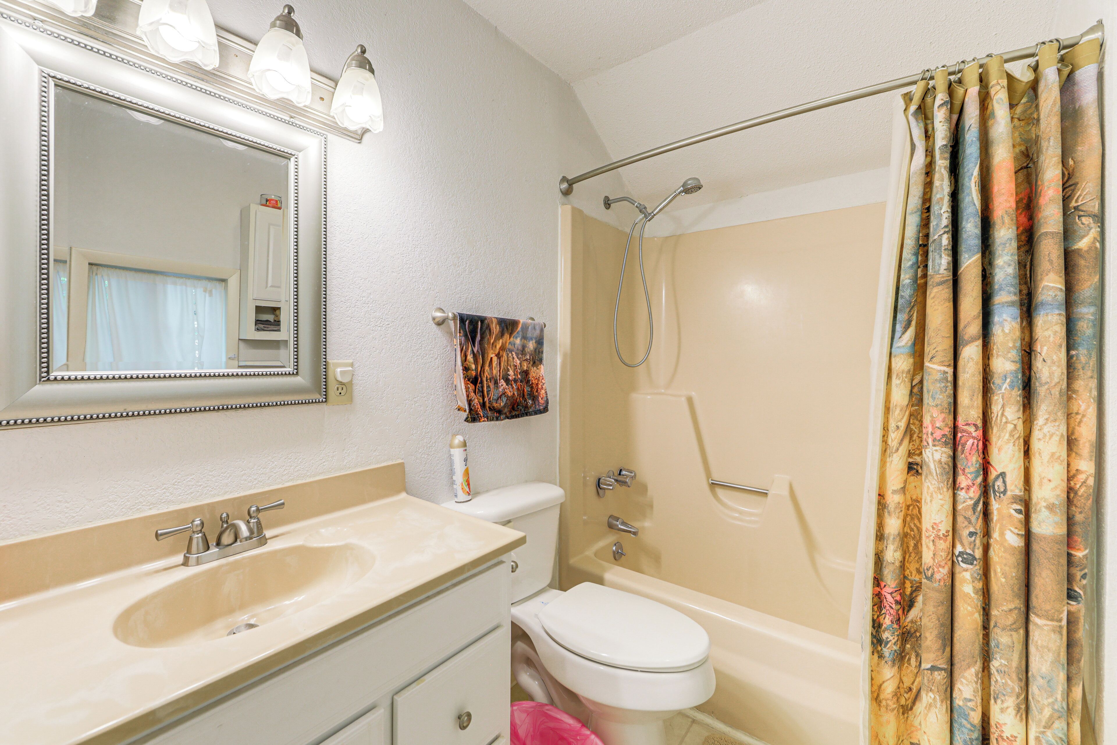 A bathroom with a sink, toilet, and bathtub.
