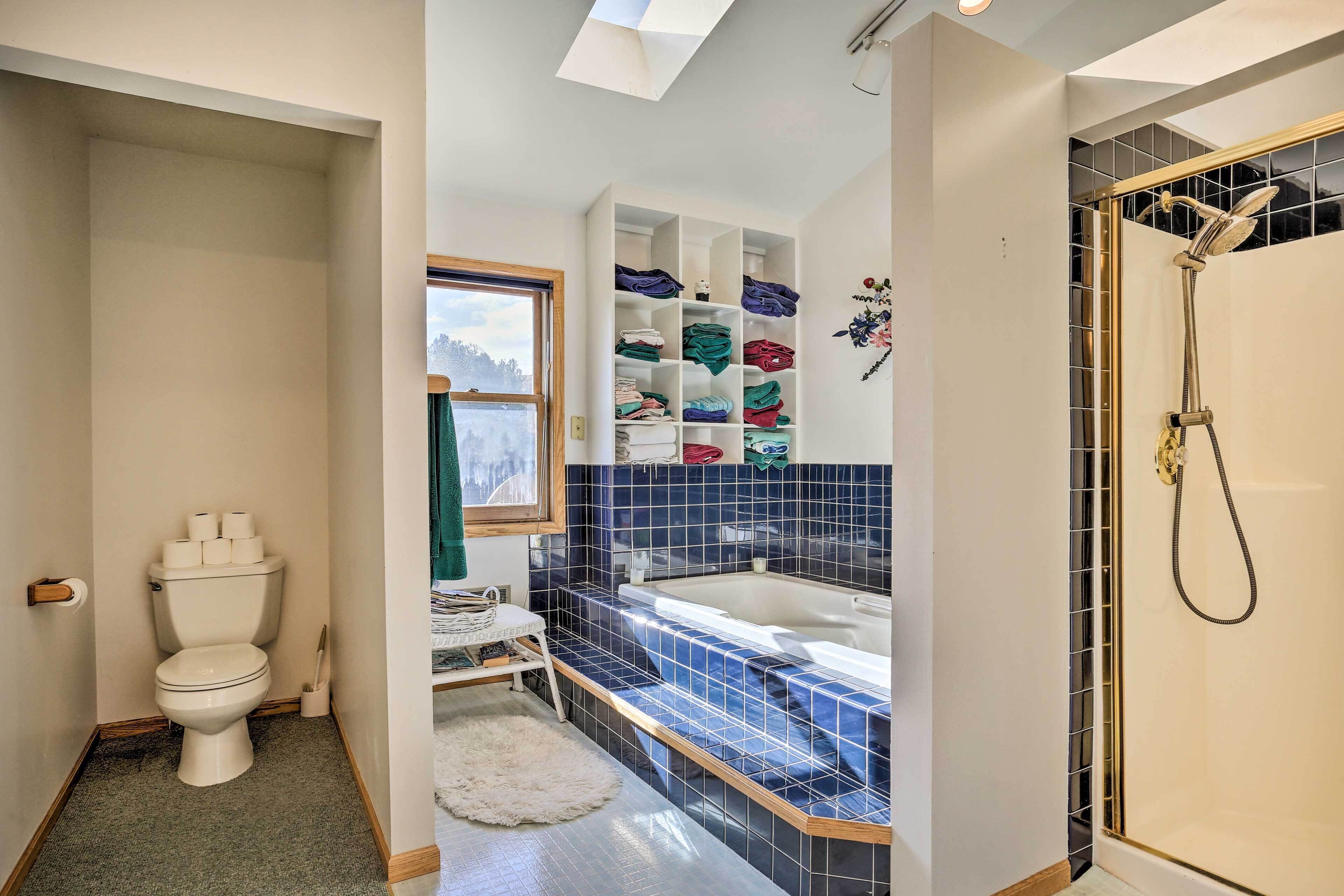 A bathroom with a toilet, a sink, a bathtub, and a shower.