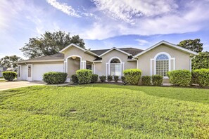 A two-story house with a well-maintained lawn, a garage, and a driveway. - Ocala Gem: 5 Mi to World Equestrian Center! (Ocala)