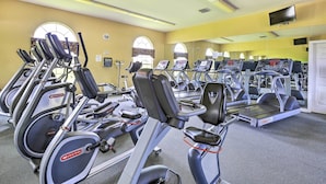 A gym with multiple treadmills and stationary bikes, large windows, and a mirror wall. - Ocala Gem: 5 Mi to World Equestrian Center! (Ocala)